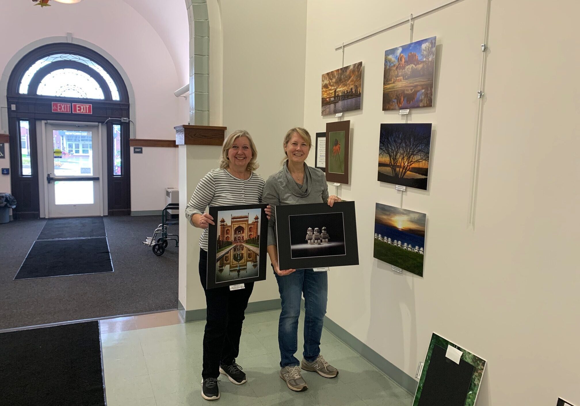 Rhonda Cullens, left, Flagpole Photographers Exhibit Chair and Sandy Schill, NECCC (New England Camera Club Council) representative, present their contribution to the “Newtown and Beyond” photography show at the Newtown Municipal Art Gallery through December 8.